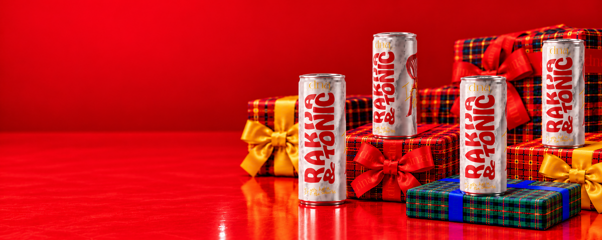 Four DNA Rakija and Tonic cans displayed on colourful tartan Christmas gifts.